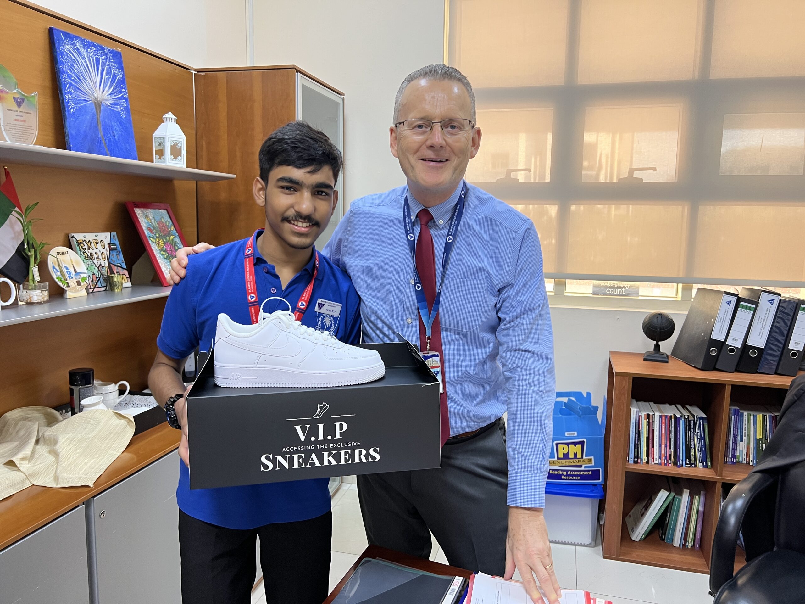 St Marys Dubai art student being presented a pair of sneakers from VIP Sneakers for winning the sneaker design competition